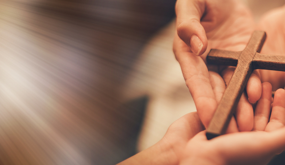 Woman's hand with cross .Concept of hope, faith, christianity, religion, church online.